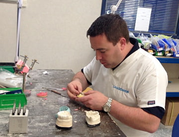 Working on custom-made cosmetic dentures Working on custom-made cosmetic dentures